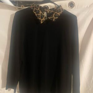 Black knit sweater with animal print collar.